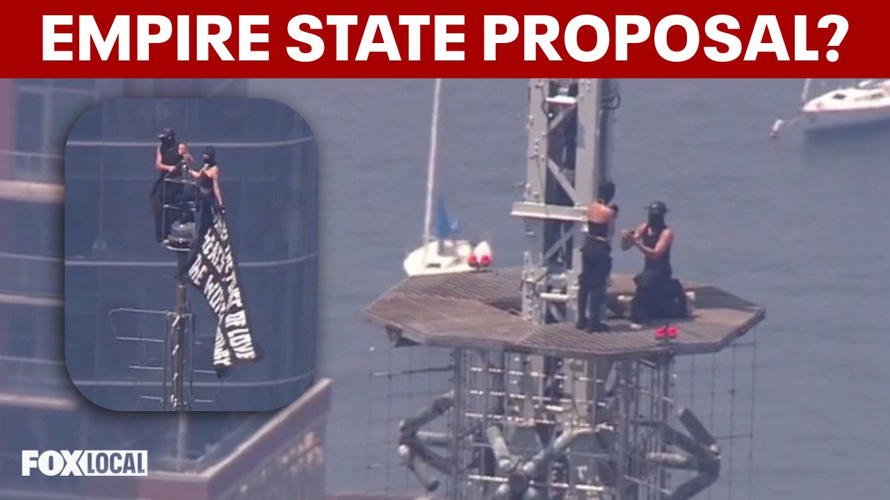Video thumbnail for Partner proposes on Empire State Building spire after climbing to raise flag