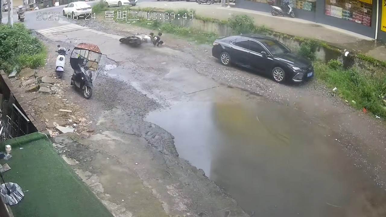 Video thumbnail for Motorcycle Swerves to Avoid Puddle and Hits Parked Car in China