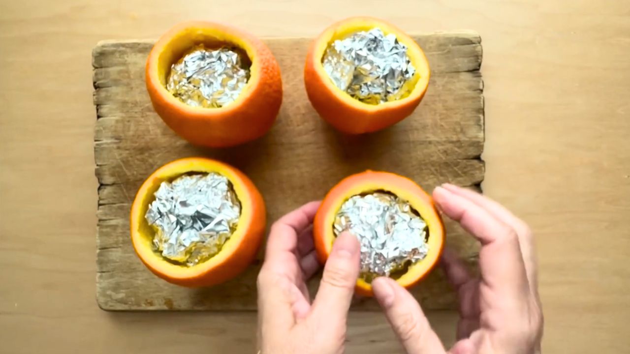 'Video thumbnail for She stuffs silver foil into orange peels for this GENIUS window idea!'