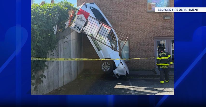 Video thumbnail for Car hangs over retaining wall after Bedford crash