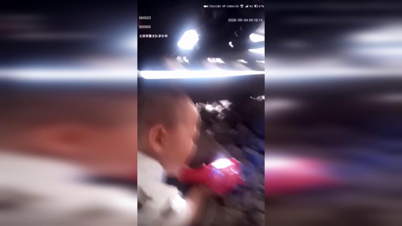 Video thumbnail for China: Police officer crawls under train to save child in Taiyuan.