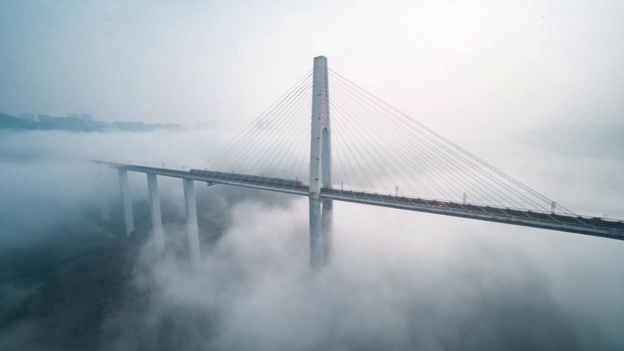 Video thumbnail for China: Otherworldly fog turns Chongqing bridge into dreamscape as metro train passes.