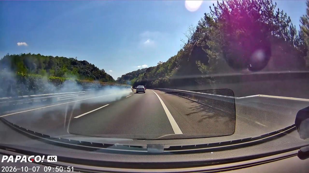 Video thumbnail for China: Chinese driver nearly blinded by thick exhaust smoke from car ahead on expressway.