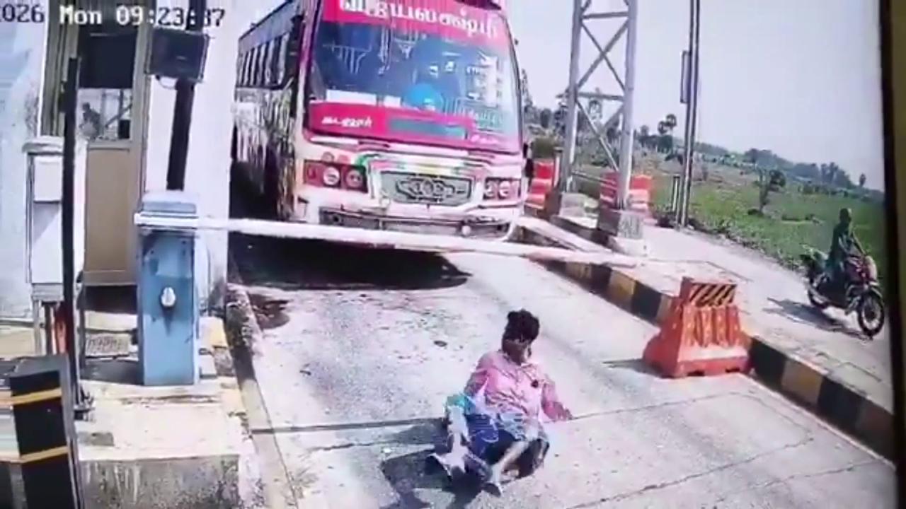 Video thumbnail for India: Man suffers violent blow to head as automatic boom barrier descends suddenly, sending him crashing onto road.