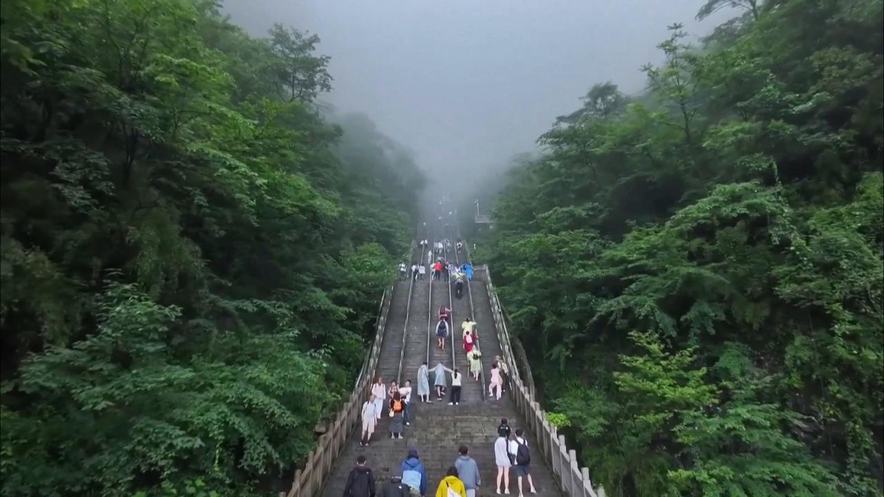 Video thumbnail for China: Clouds cross through Tianmen Cave, enchant visitors.