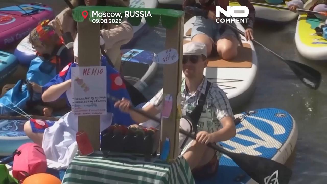Video thumbnail for Costumed paddleboarders float down Moscow river in carnival