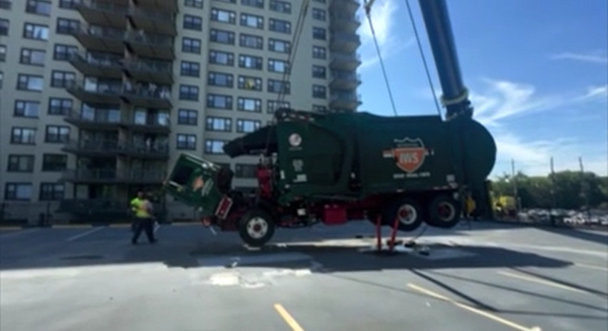 Video thumbnail for It's out!! Crews remove trash truck stuck in Clifton parking garage deck