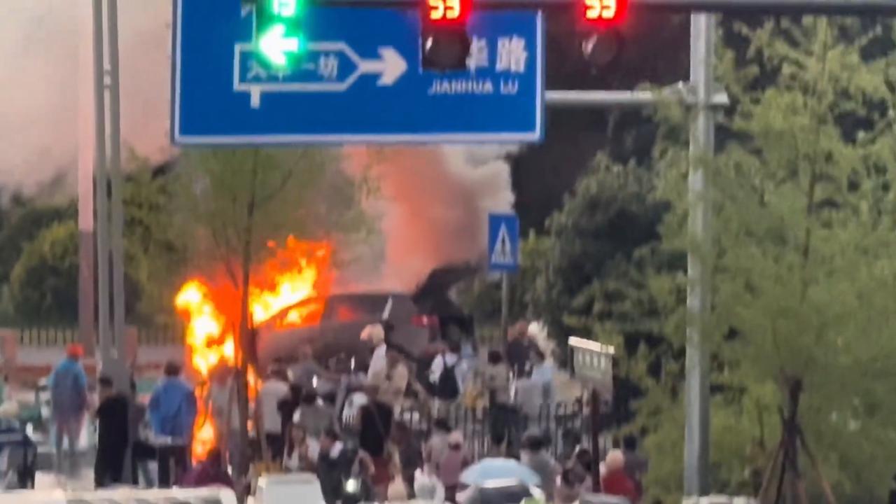 Video thumbnail for China: Car fire sparks panic on road in China as burning SUV blocks traffic.