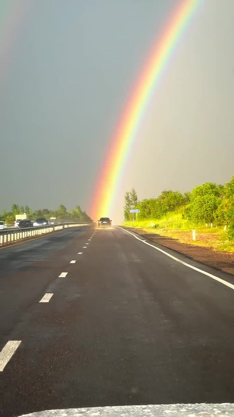 Video thumbnail for Driving into a Brilliant Rainbow on a Wet Highway
