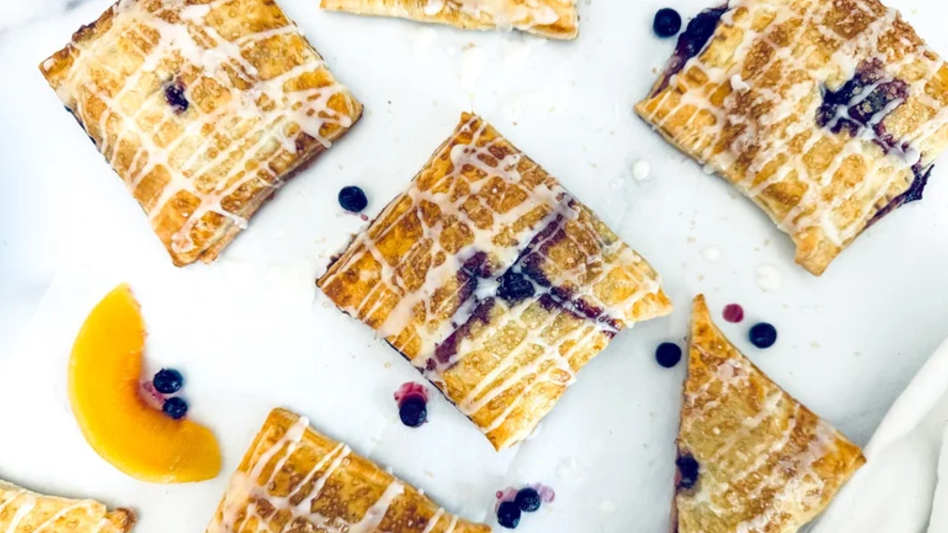 Video thumbnail for Almond-Glazed Blueberry Peach Hand Pies Recipe