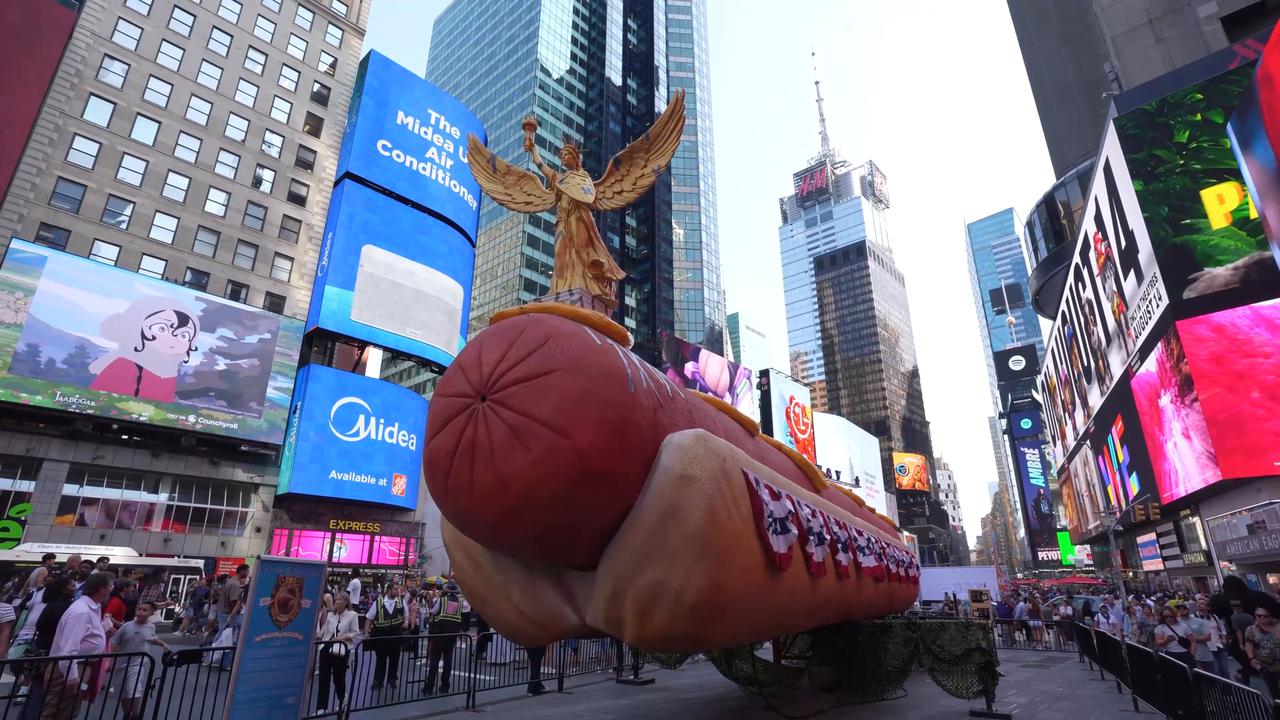 Video thumbnail for US: Giant hot dog sculpture returns to New York's Times Square.