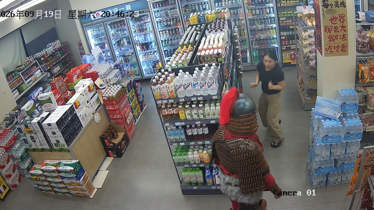 Video thumbnail for Man in Traditional Armor Surprises Store Worker in Guangxi