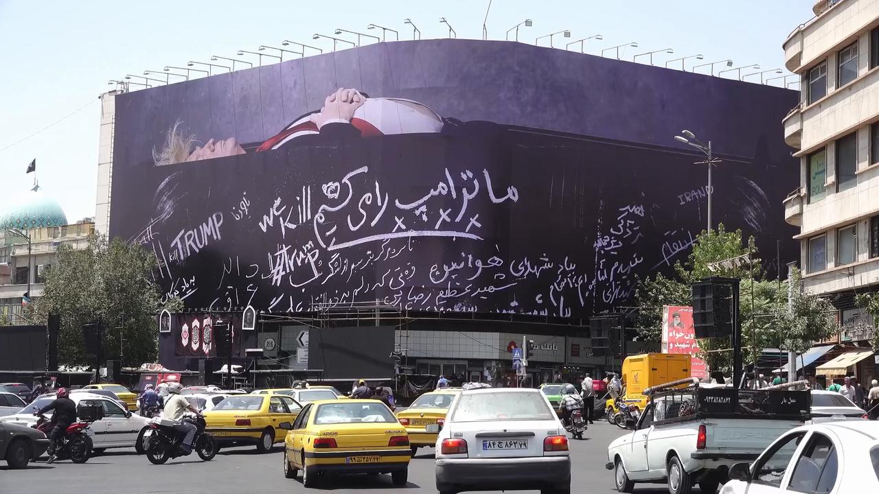 Video thumbnail for Iran: Trump-in-coffin poster displayed in central Tehran.