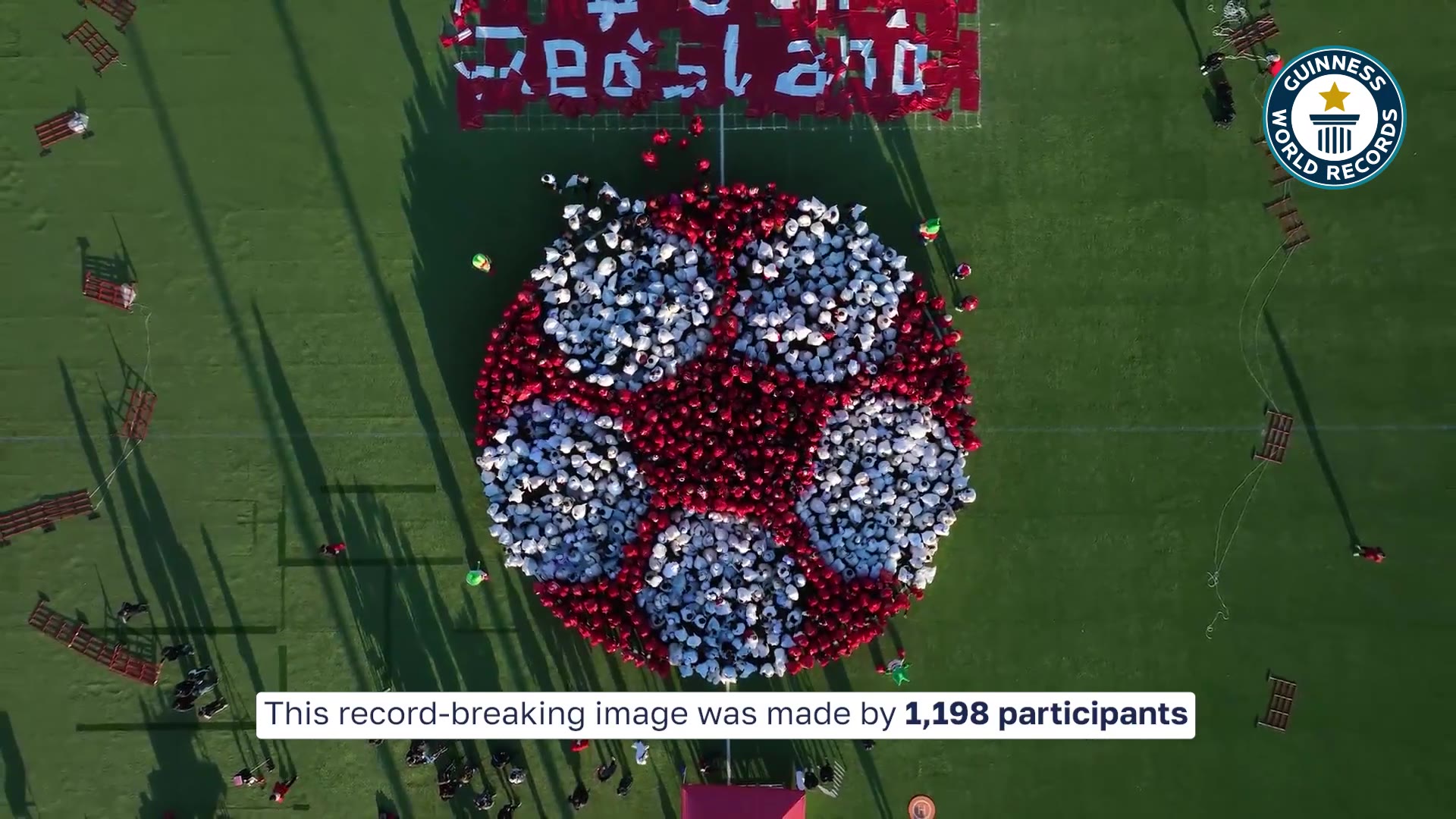 Video thumbnail for Largest human image of a football (soccer ball)  1,198 people by RedsLand