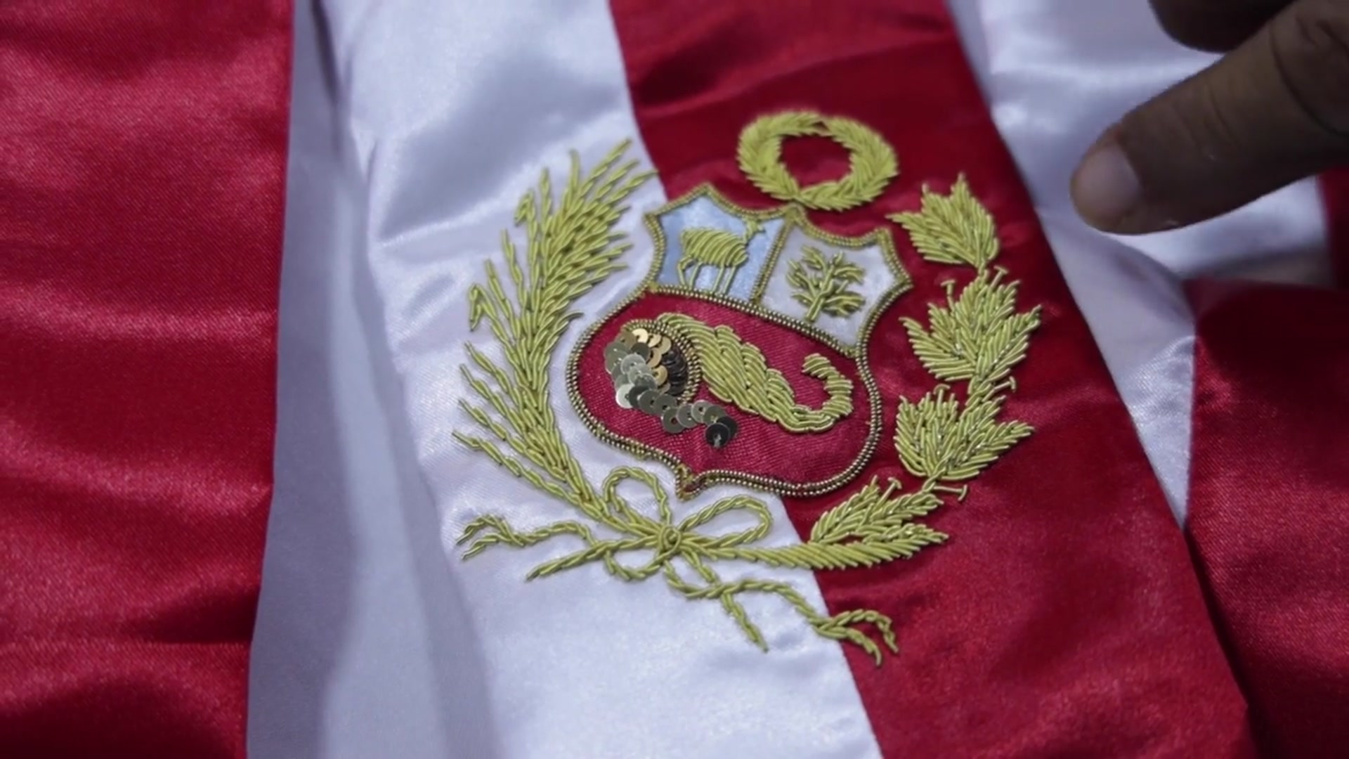 Video thumbnail for Peru: Peruvian master embroiderer prepares presidential sash ahead of inauguration.