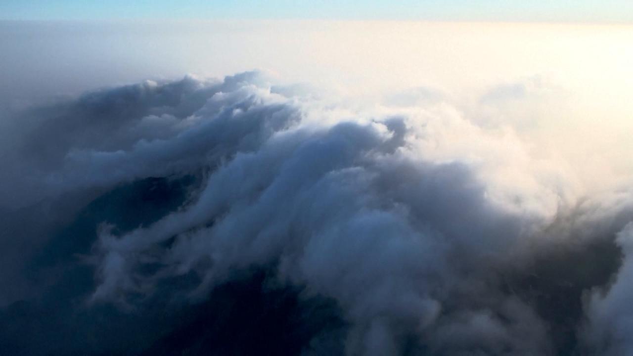 Video thumbnail for China: Cloud waterfall unfolds a stunning view over east China's Lushan Mountain.