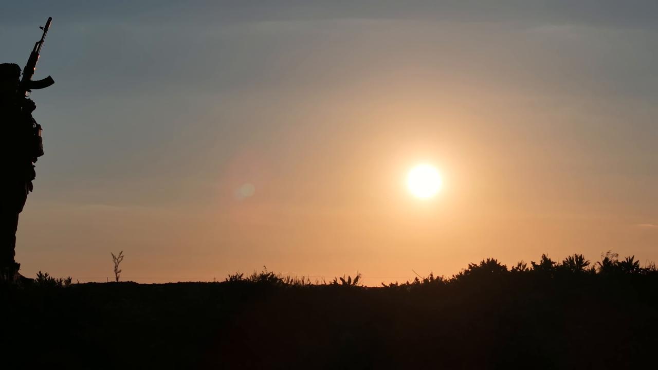Video thumbnail for Syria: Silhouette of Syrian soldiers in military uniform at sunset.