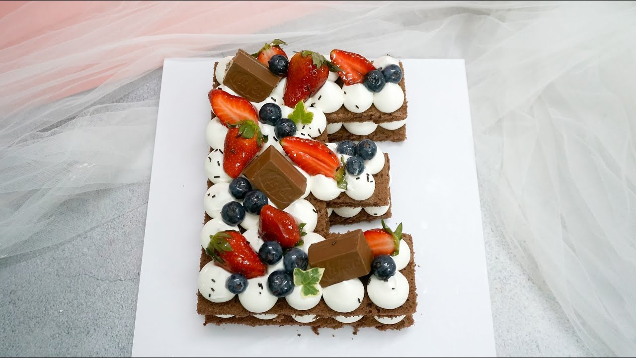 'Video thumbnail for E shaped cake decoration with strawberries fruit for happy birthday'