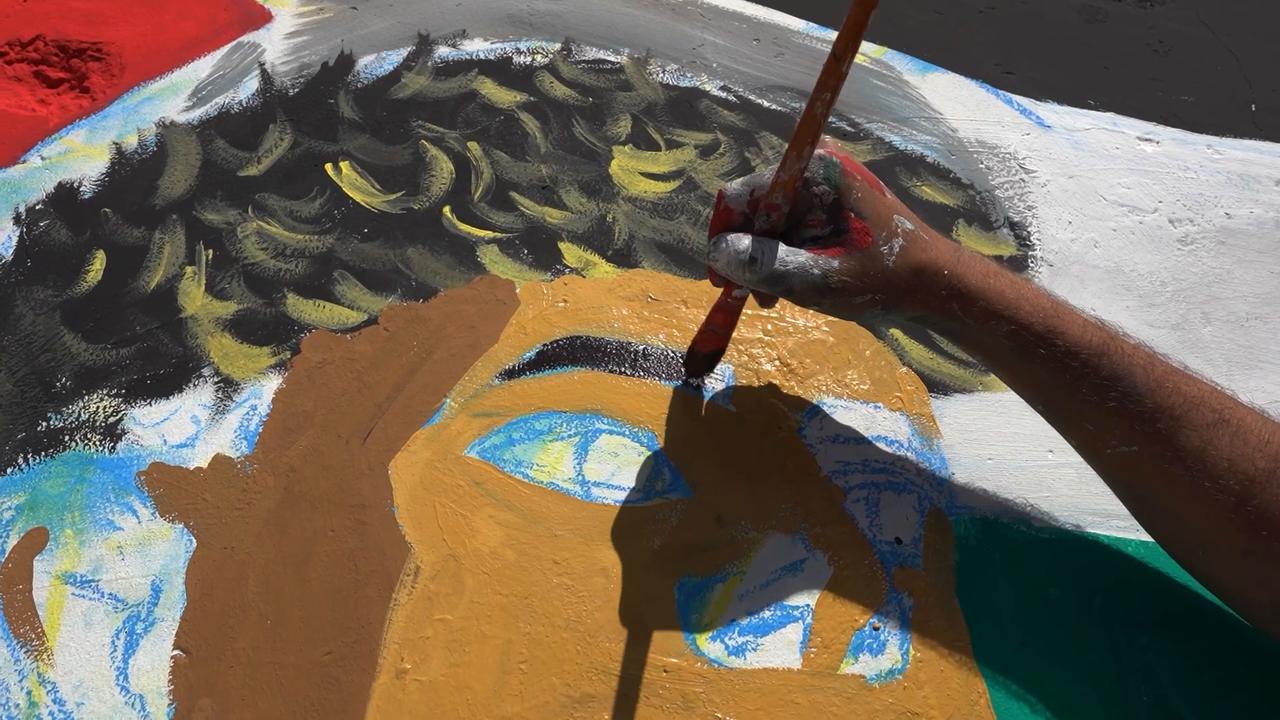 Video thumbnail for Gaza artists paint footballer Lamine Yamal mural on rubble honoring his solidarity gesture.