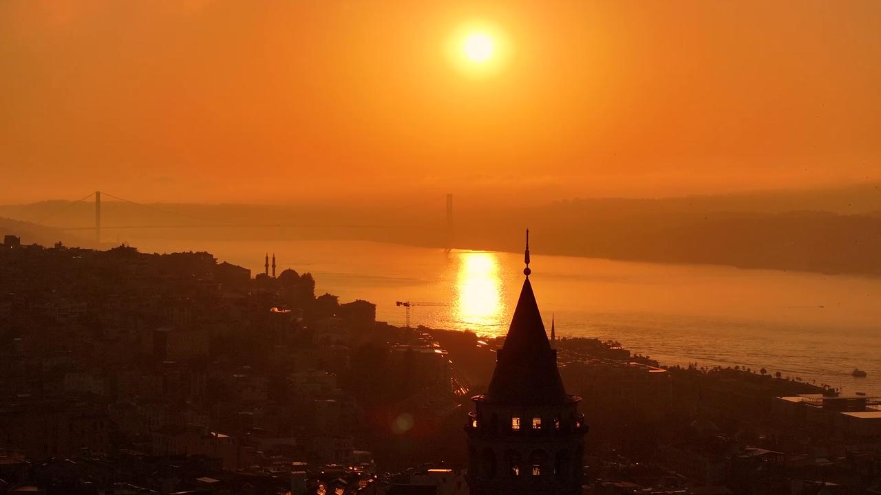 Video thumbnail for Türkiye: Sunrise over Bosphorus frames Istanbul's iconic Galata Tower.