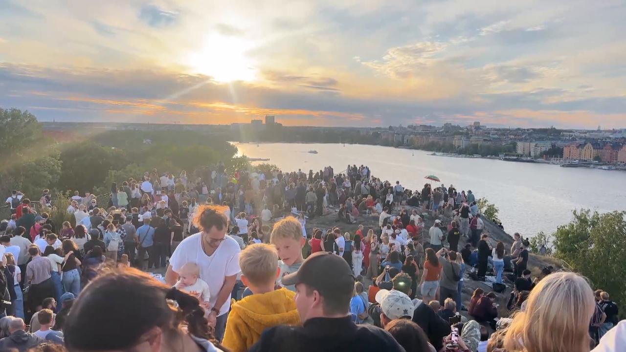 Video thumbnail for Sweden: Crowds in Stockholm gather in open area to observe partial solar eclipse.