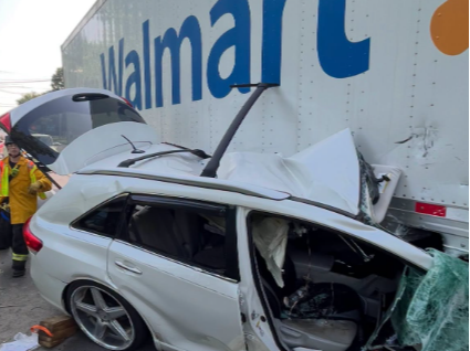 Video thumbnail for Firefighters free two people after vehicle becomes wedged under Walmart tractor-trailer
