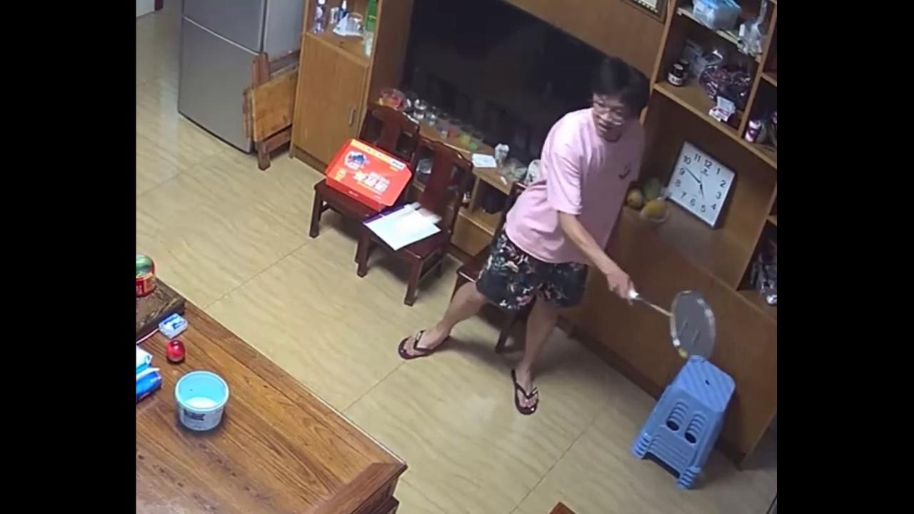 Video thumbnail for China: Chinese man hits shuttlecock into small box on table.