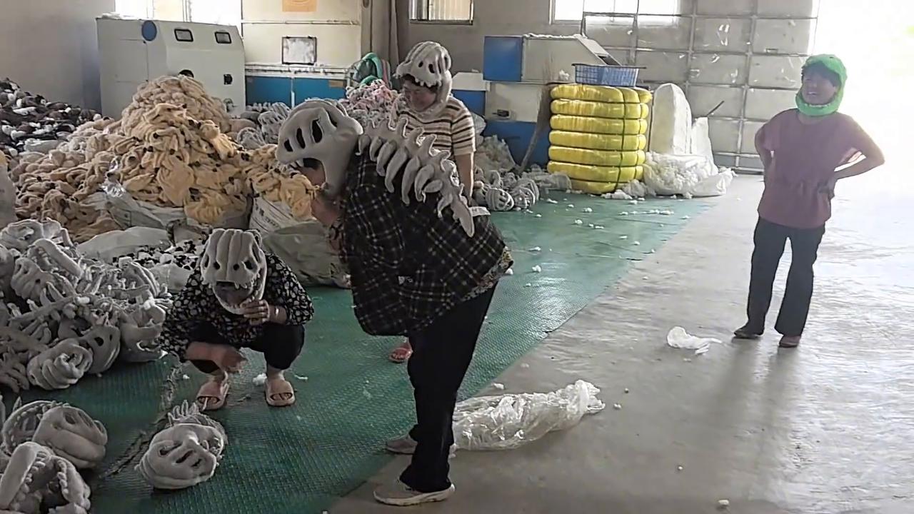 Video thumbnail for China: Factory women wearing dinosaur headgear.
