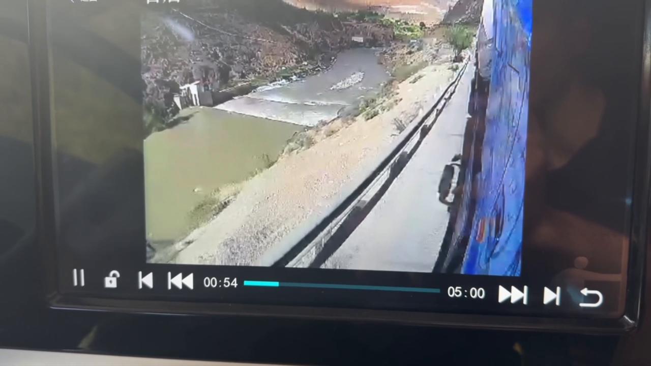 Video thumbnail for China: Chinese cyclist jumps roadside barrier as turning semi-trailer squeezes past.