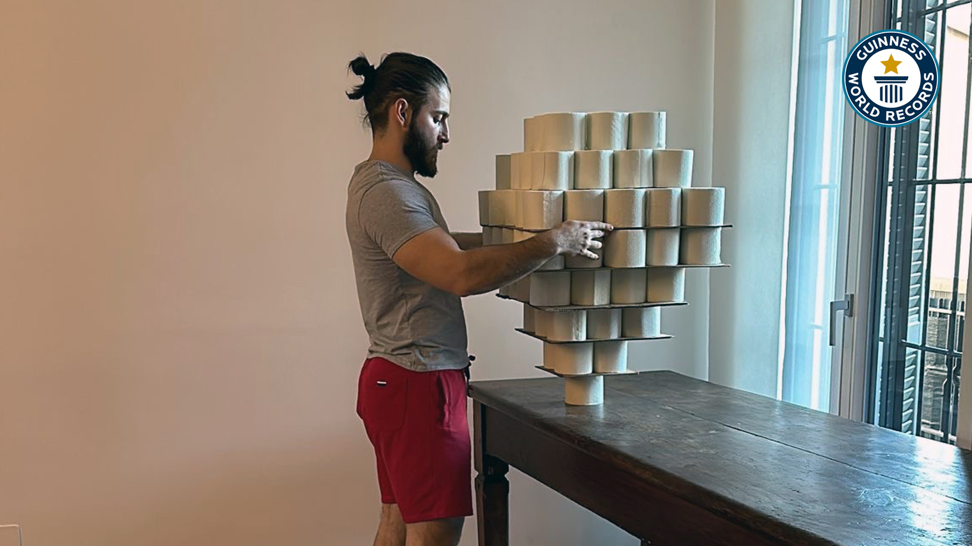 'Video thumbnail for Federico Pavone balances toilet paper rolls on his head for a world record'
