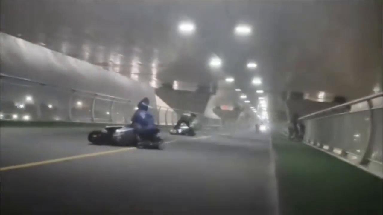 Video thumbnail for China: Cyclists caught in a storm on a bridge.