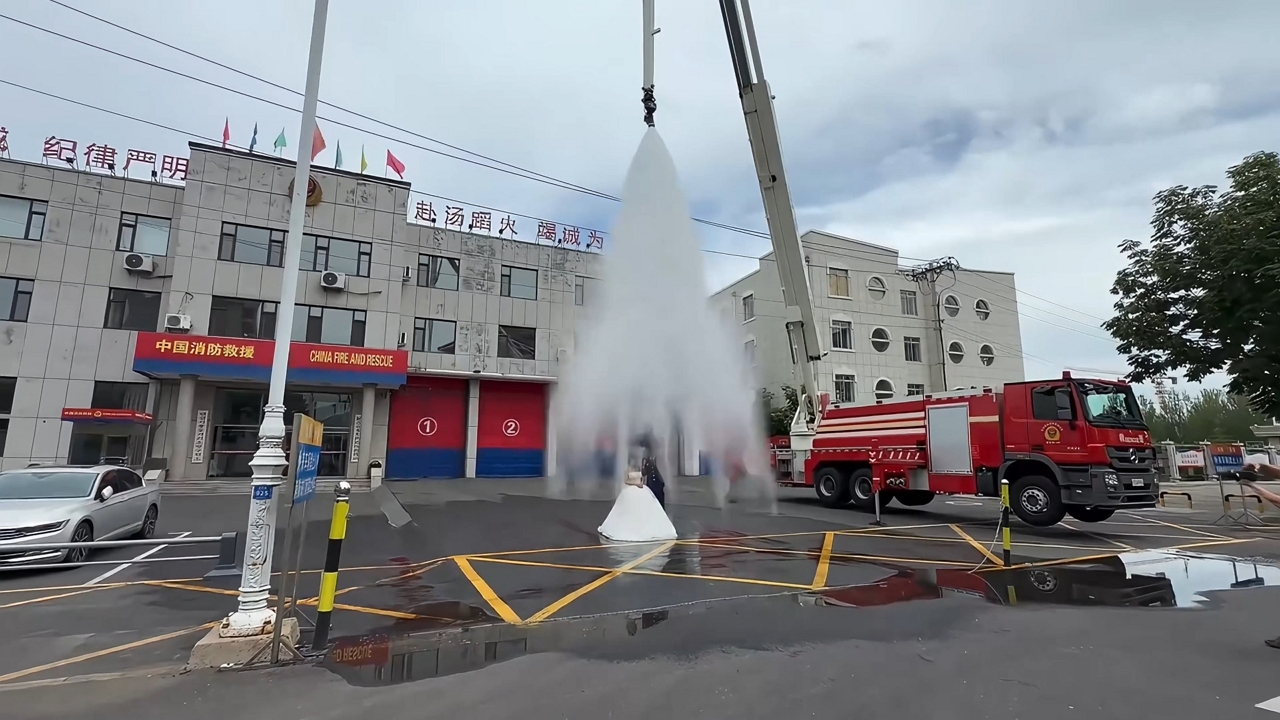 Video thumbnail for Epic Firefighter Wedding Photoshoot Soaks the Couple!