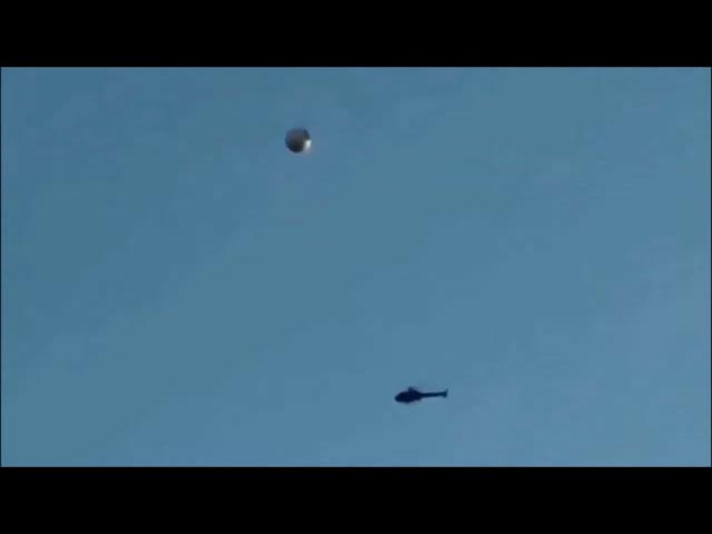 Video thumbnail for Clear video footage of a UFO, with a helicopter hovering below it in the Los Angeles sky.