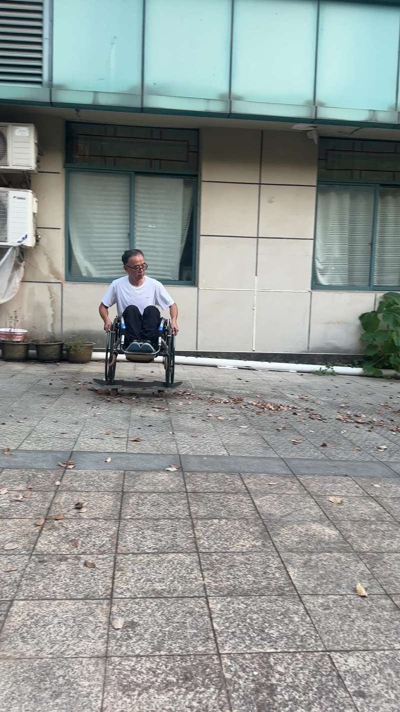 Video thumbnail for Wheelchair Ride across the Courtyard on a Skateboard
