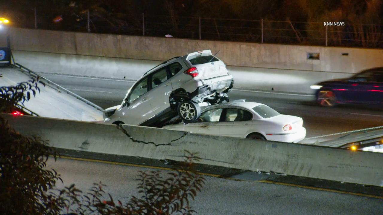 Video thumbnail for US, Los Angeles: Commerce SUV Rests on Top of Car After Crash on 5 Freeway.