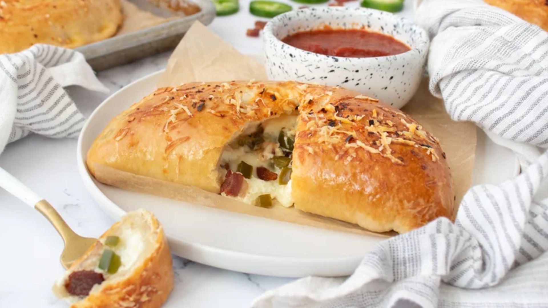 Video thumbnail for Cheesy Jalapeño Bacon Calzones Recipe