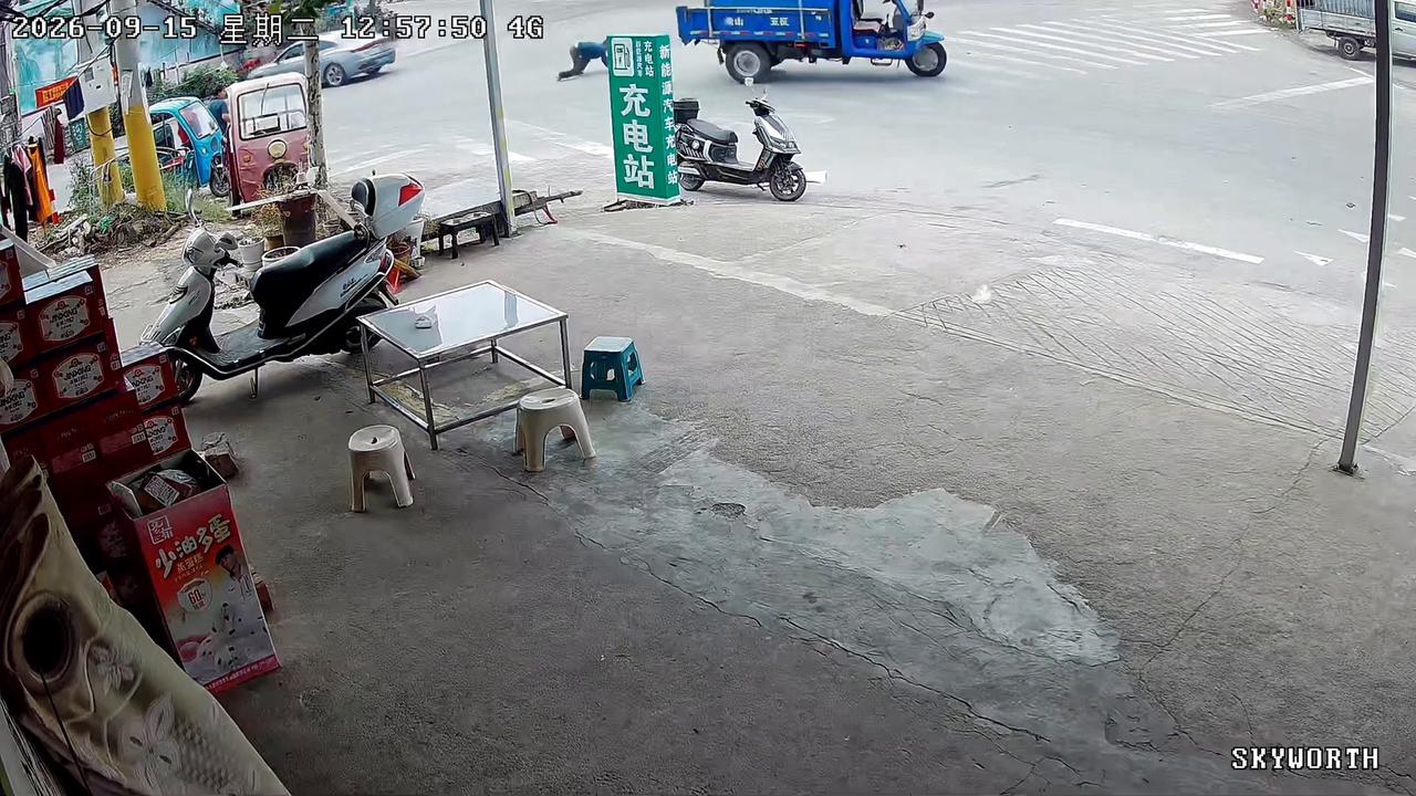 Video thumbnail for China: Chinese driver thrown to ground when tricycle overturns at intersection.