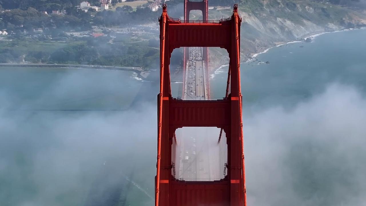 Video thumbnail for US: DRONE - Fog shrouds San Francisco’s Golden Gate Bridge, creating scenic views.