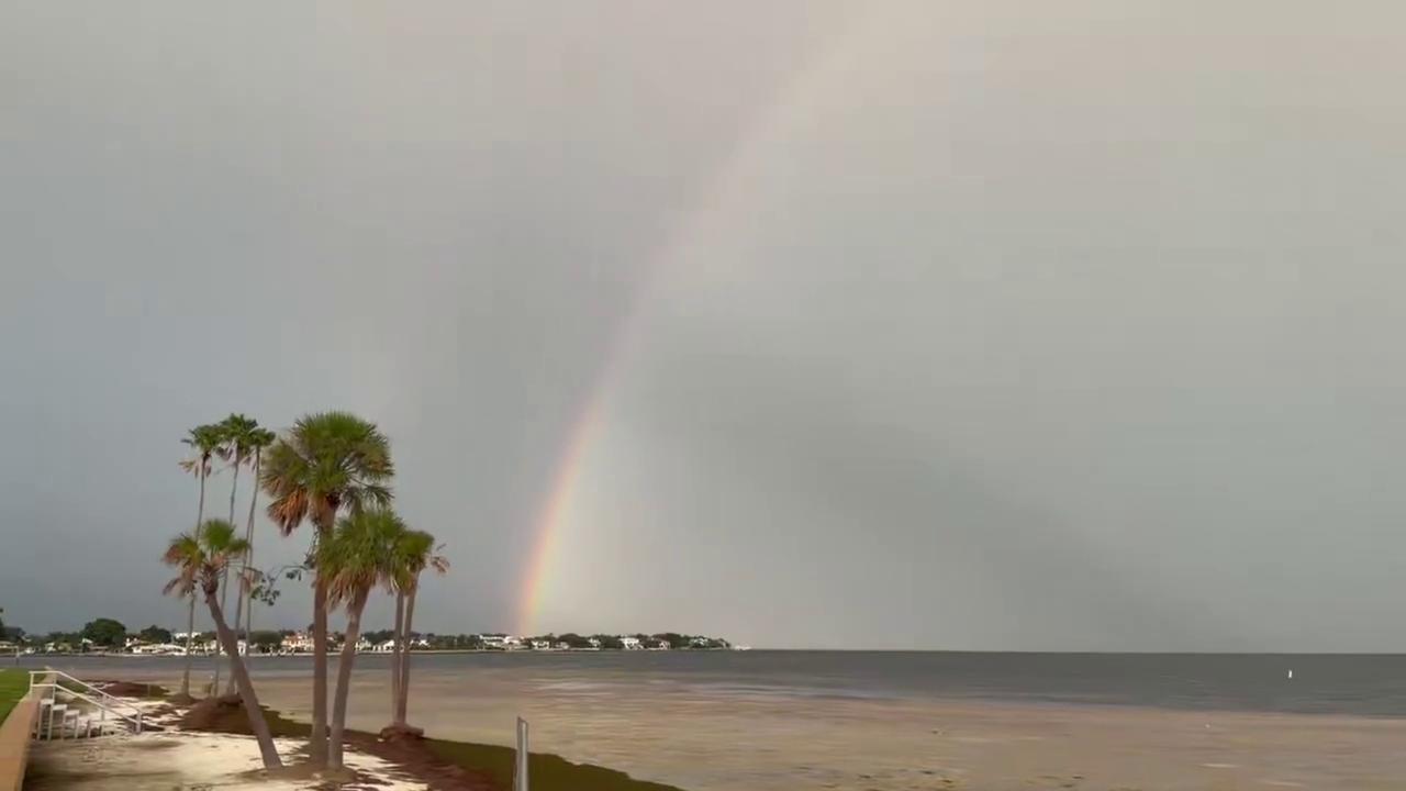 Video thumbnail for US: Tampa Bay Sky Erupts In Color As Rainbow And Massive Cloud Bank Rise Over The Water.
