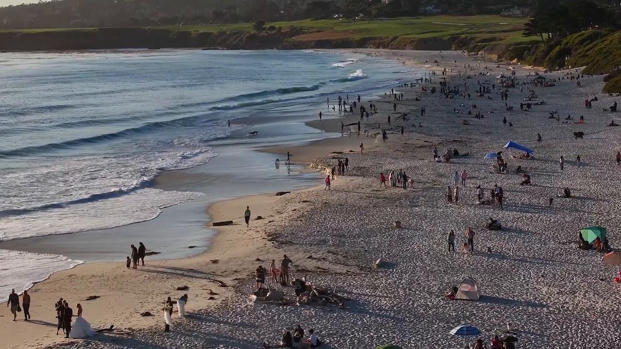 Video thumbnail for US: Warm weather brings visitors to Carmel Beach.