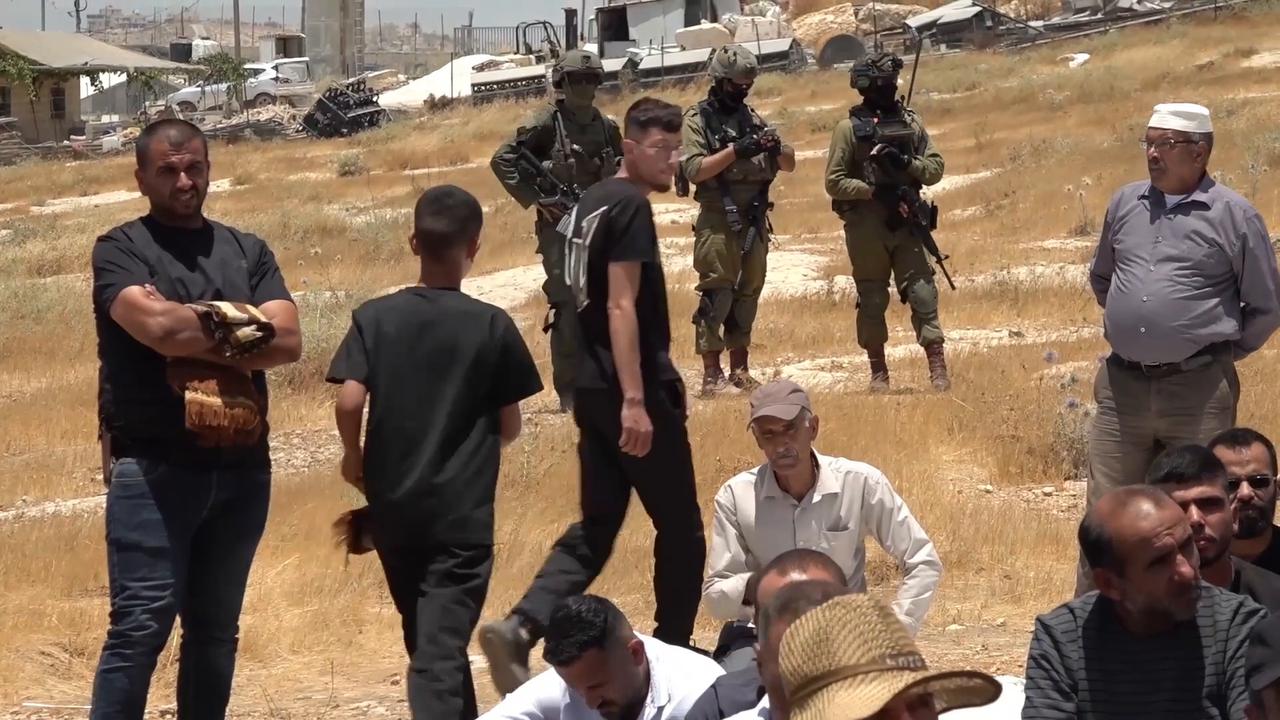 Video thumbnail for Palestinians in Hebron perform Friday prayers on land threatened with seizure by Israeli settlers.