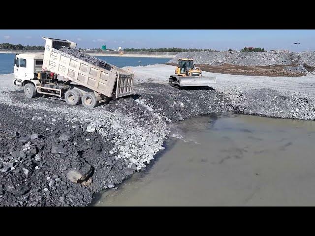 Video thumbnail for Processing Filling Stone to Large Area Use Bulldozer Push Stone and Dump Truck Transport Stone Fi