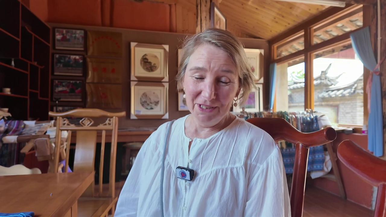 Video thumbnail for China: Foreign tourist experiences ethnic embroidery in China's Yunnan.
