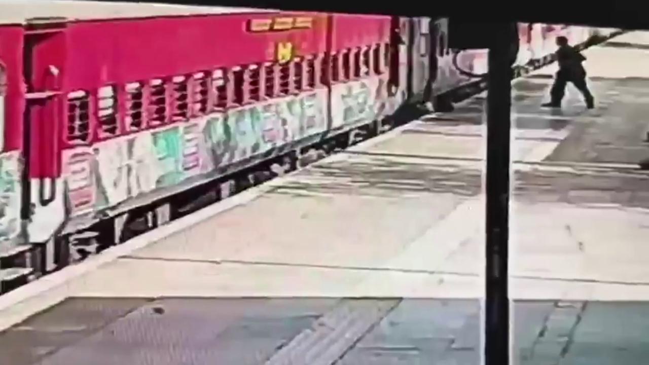 Video thumbnail for India: Passenger trapped between moving train, platform in Delhi as alert official risks life to pull him to safety.