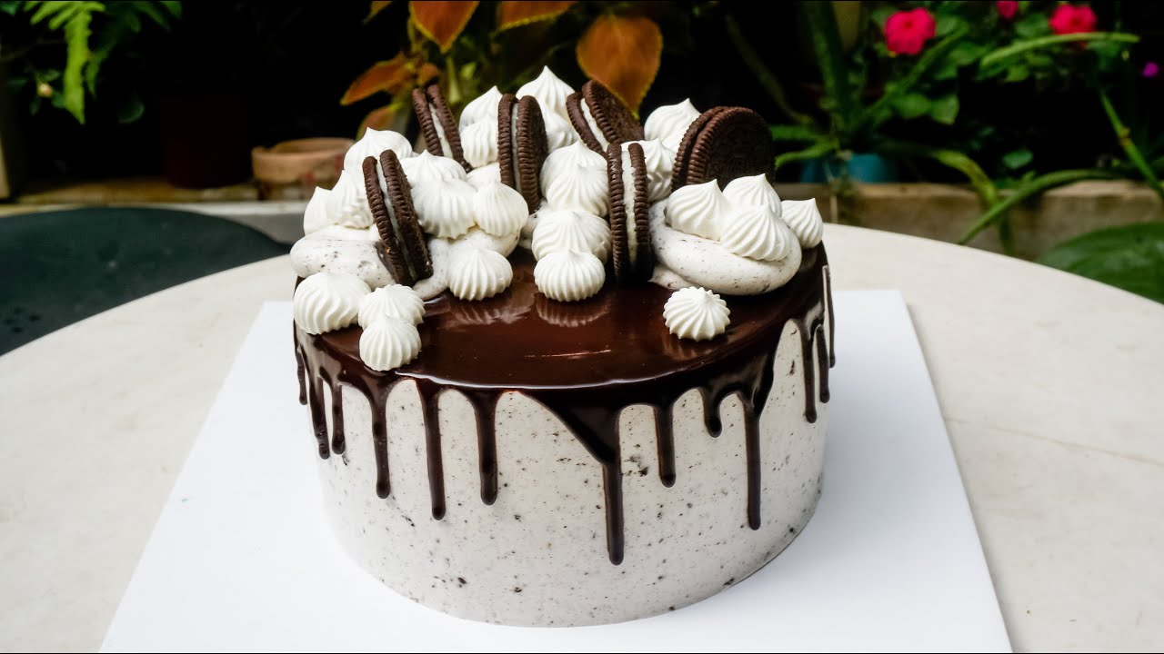 'Video thumbnail for Birthday cake decoration is sprinkled with chocolate powder on cream shaped leaf'