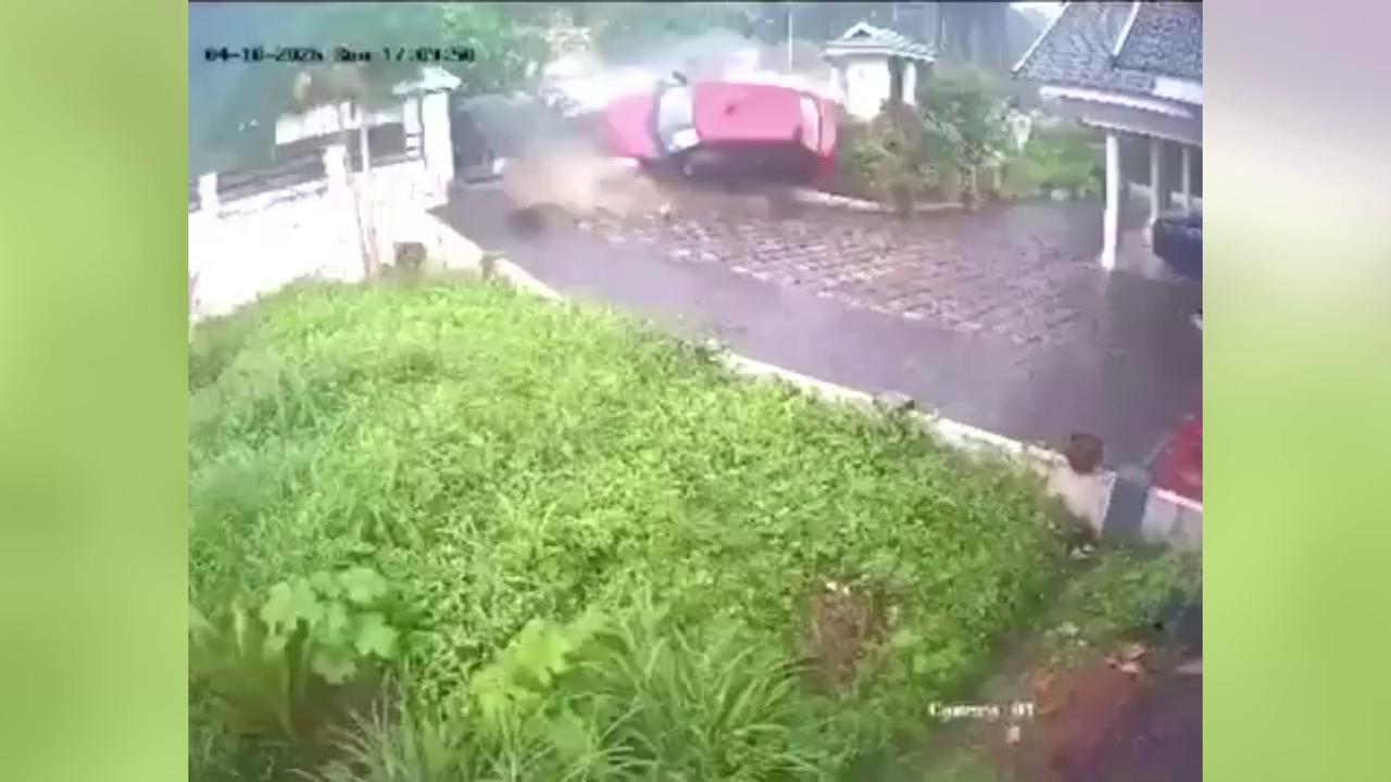 Video thumbnail for India: Car smashes through boundary wall, lands upside down in garden as occupants escape with minor injuries.
