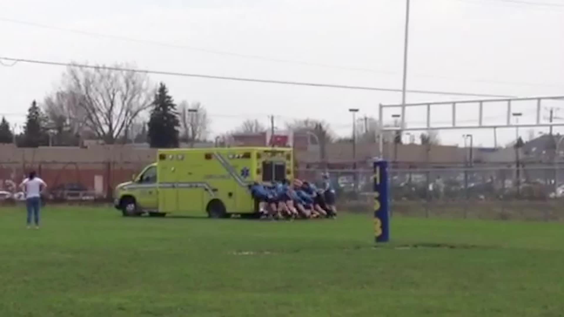 video of: Rugby Girls Push Ambulance Carrying Injured Teammate From Mud | Happily TV