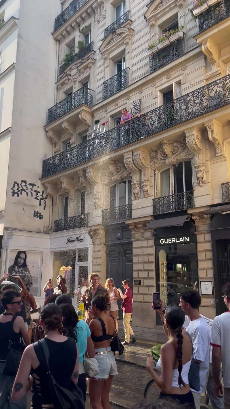 Video thumbnail for Balcony Water Shower over a Dancing Street Crowd
