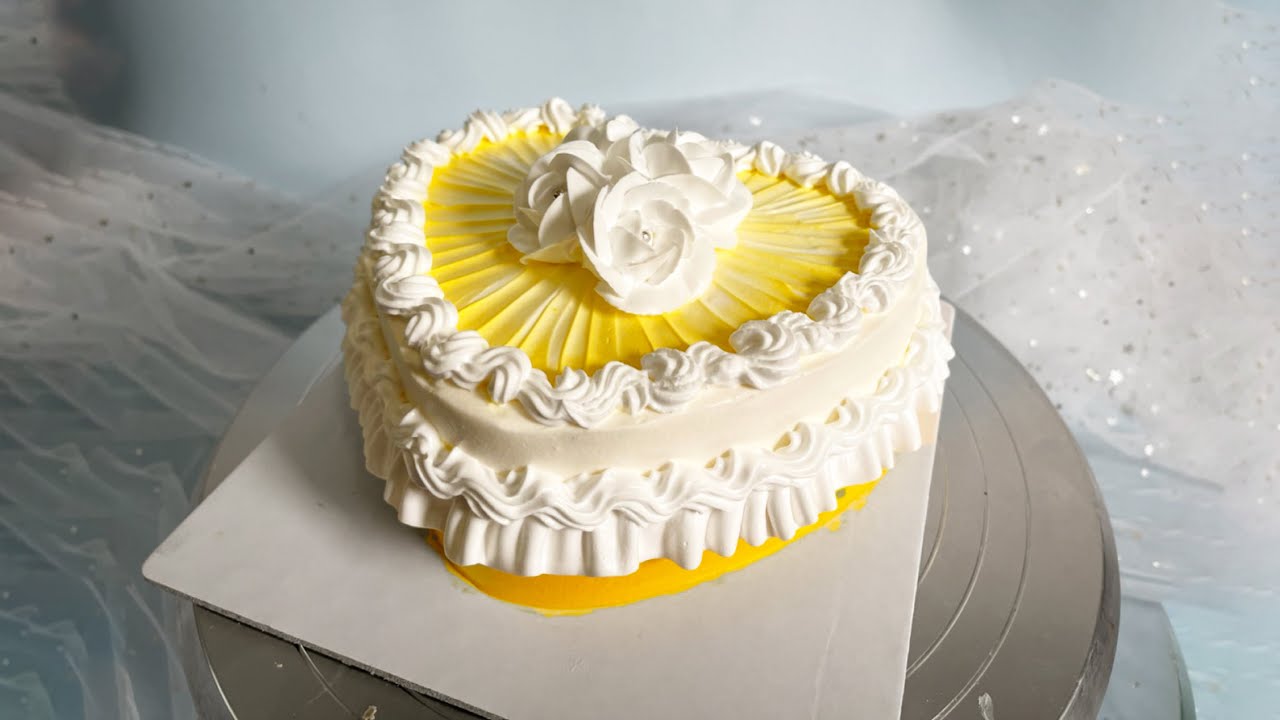 'Video thumbnail for Yellow heart shape birthday cake Heart cake with flowers for couples'
