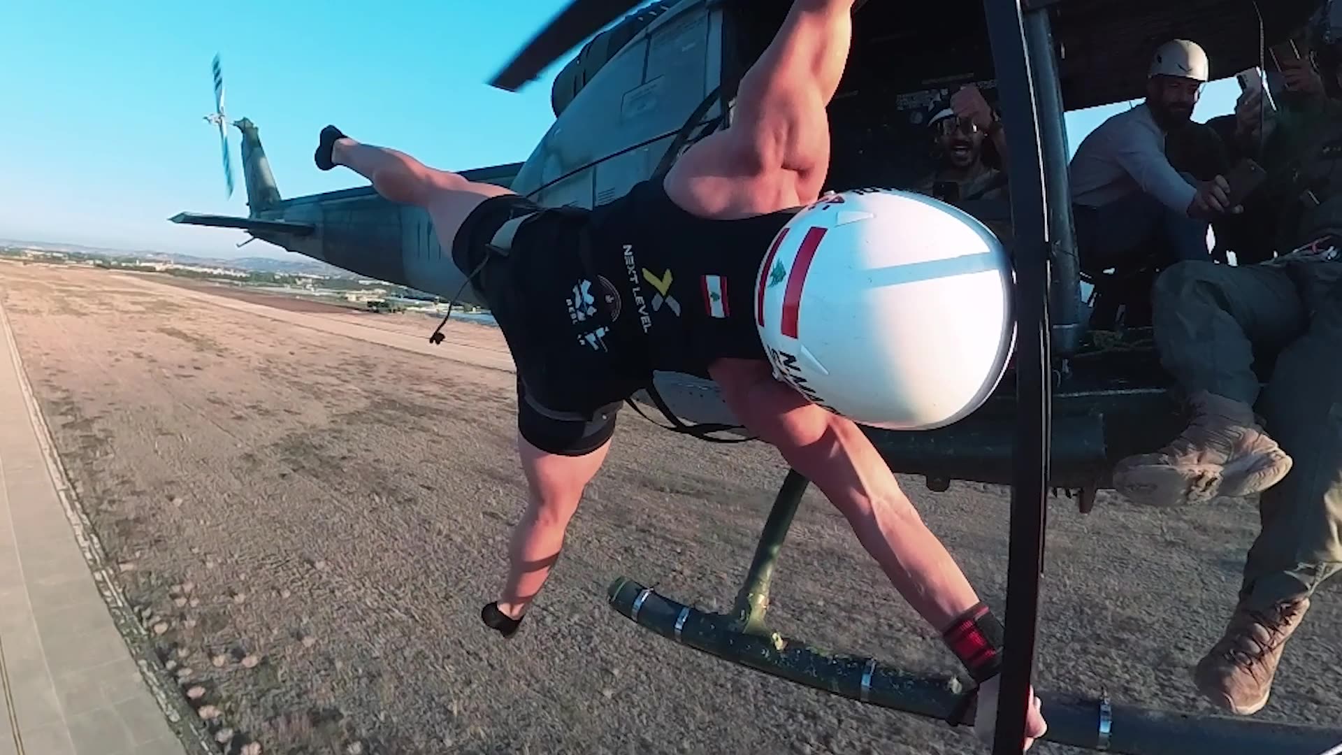 Video thumbnail for Longest duration to maintain a straddle human flag position on a flying helicopter